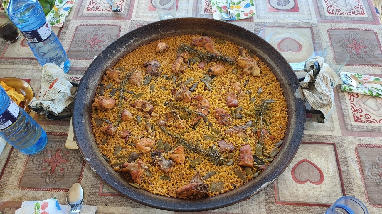 Paella decorated with fresh rosemary